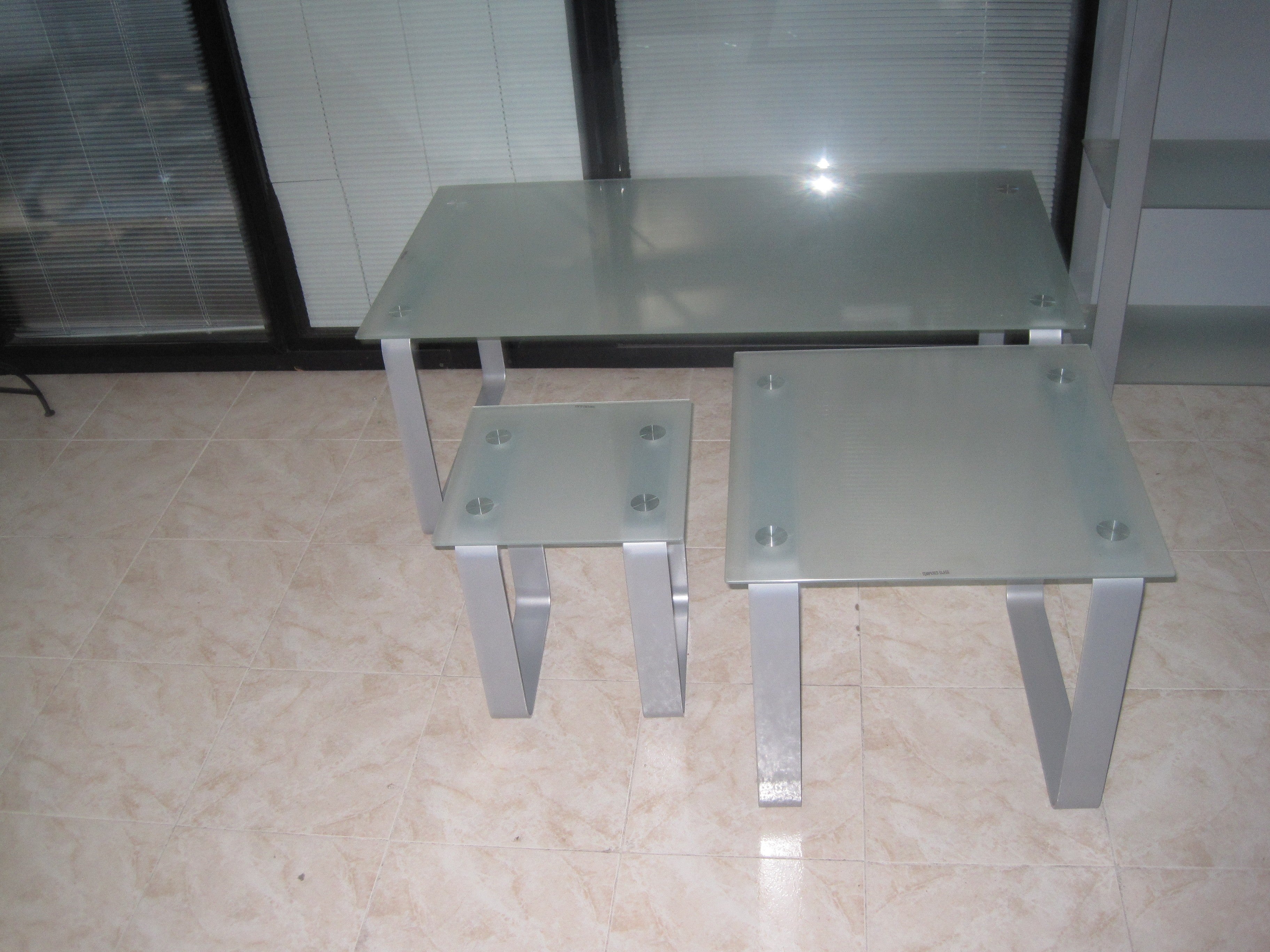 Mesa auxiliar con encimera de cristal.